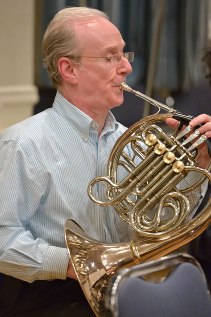 man playing french horn