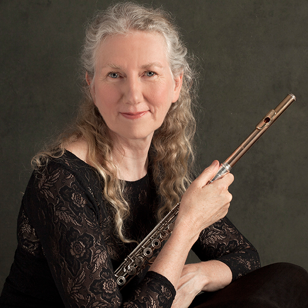 woman with grey hair holding flute