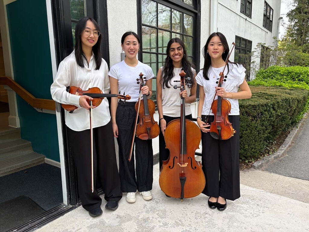 four young women holding string instruments