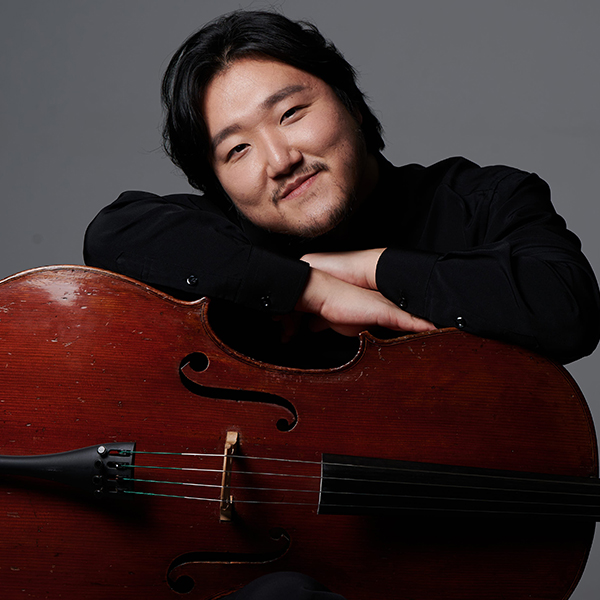 Asian man in a black shirt with a cello