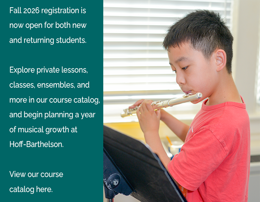 Young boy in red shirt playing the flute