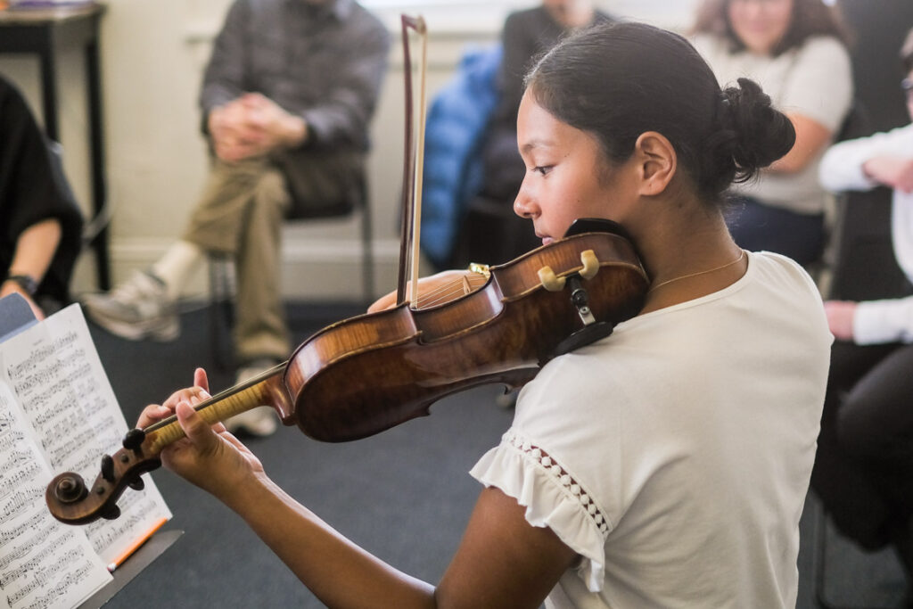 Girl playing violin in master class