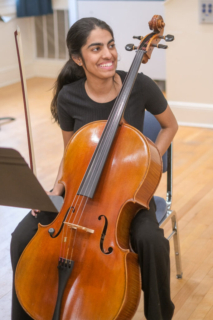 Girl smiling playing the cello