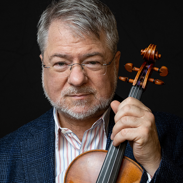 man with grey hair and mustache and beard holding a violin