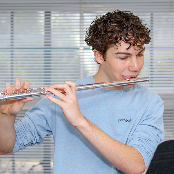 Teenage boy playing the flute