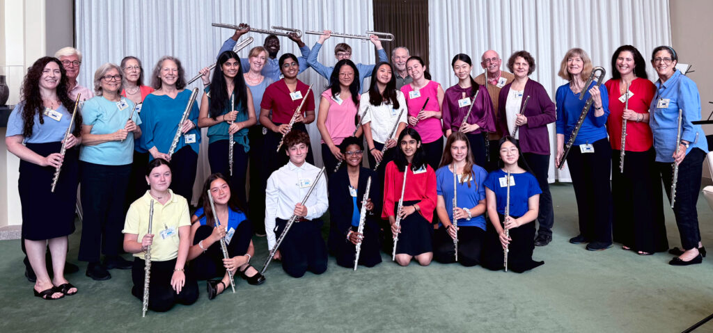 Intergenerational flute ensemble smiling and posing for the camera at the UN