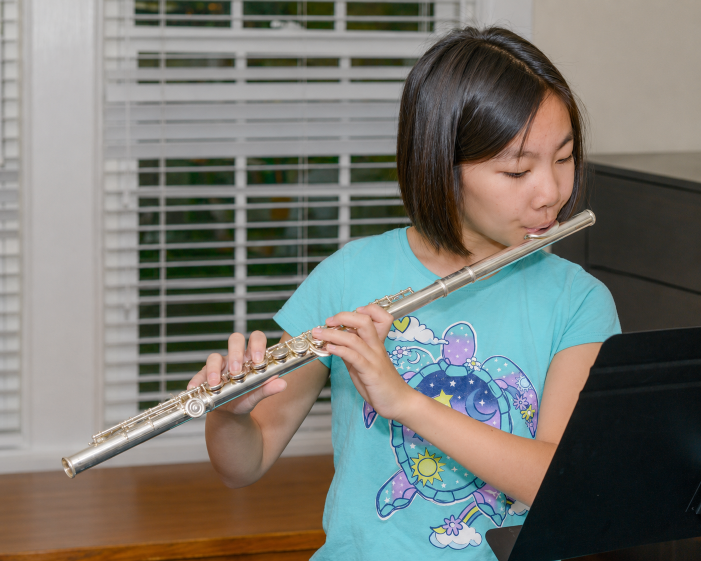 Young girl playing the flute
