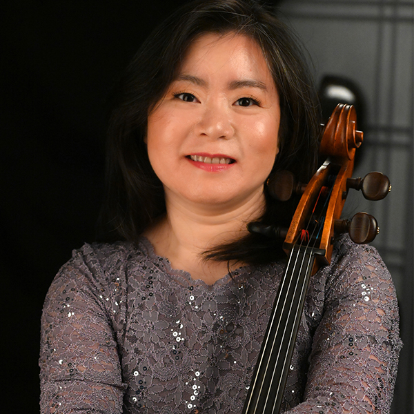 Woman dressed formally with a cello