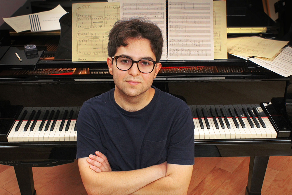 Kian Ravaei sitting at the piano