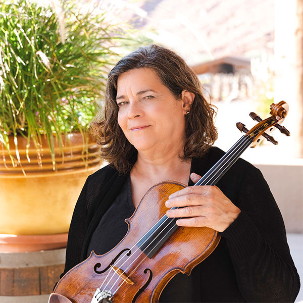 Woman with brown hair wearing a black sweater and holding a viola