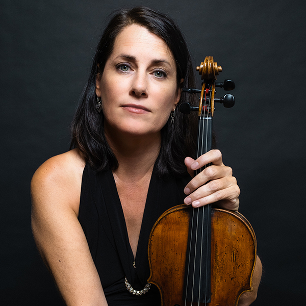 Woman in sleeveless black dress holding a violin