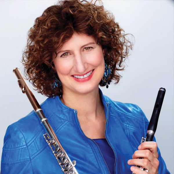 Mindy Kaufman holding a flute and piccolo