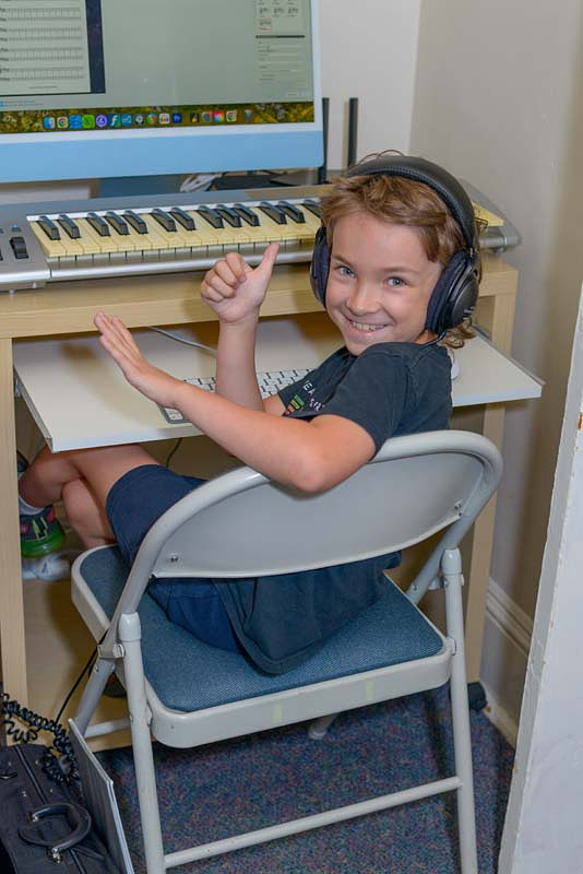 Young boy giving the thumbs up in a music tech lab