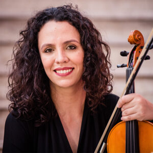 Natasha Sieczkowska smiling holding a viola
