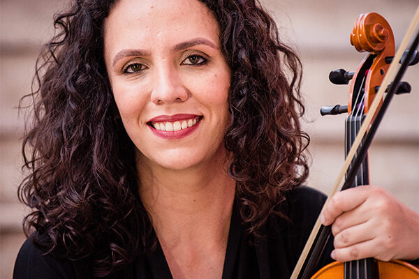 Natasha Sieczkowska smiling holding a viola