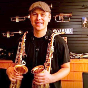 Nathan Childers holding two saxophones