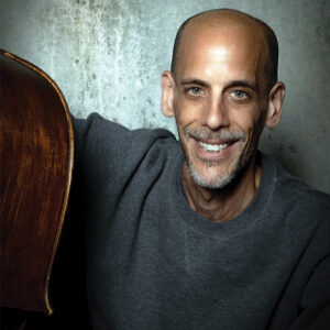 Man Smiling holding a double bass
