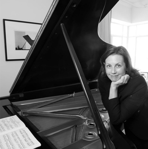 woman posing in front of an open piano
