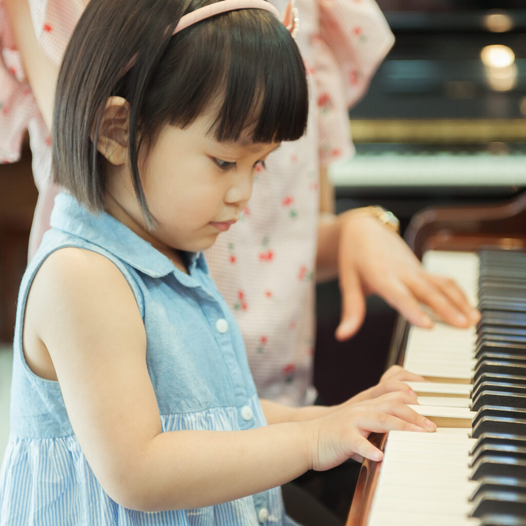 Young Asian Girl playing the piano