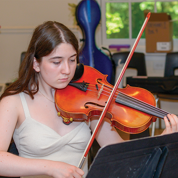 Girl in white shirt playing a violin