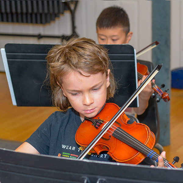 Young boy playing the violin