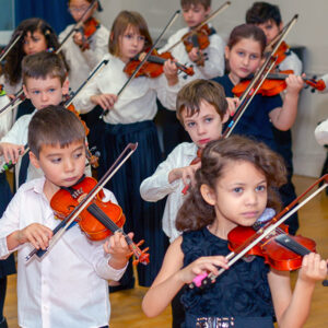 Young children playing the violin