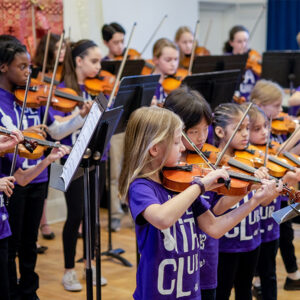 group of viola players in purple shirts