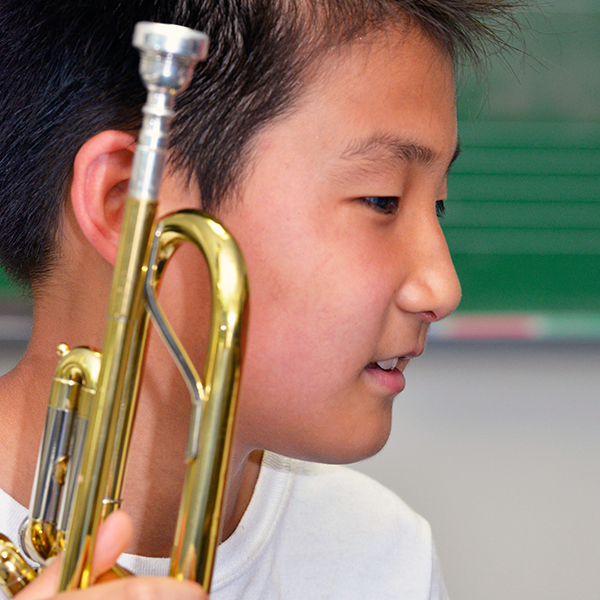 student holding trumpet